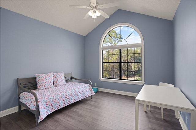 bedroom with ceiling fan, dark wood-type flooring, and vaulted ceiling