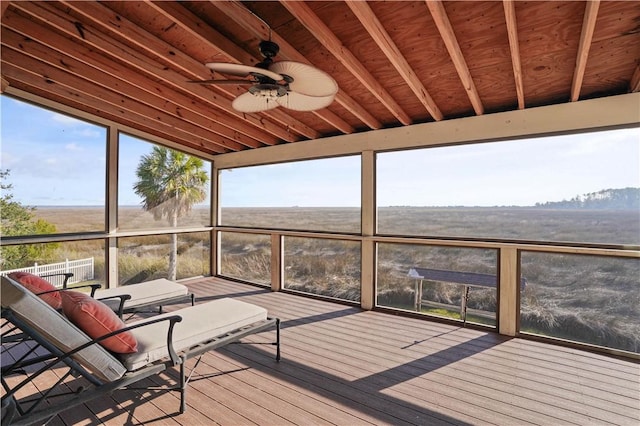 unfurnished sunroom with ceiling fan