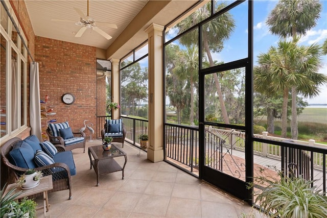 sunroom featuring ceiling fan