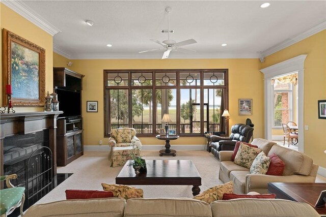 living area featuring light carpet, ornamental molding, a fireplace with flush hearth, and visible vents