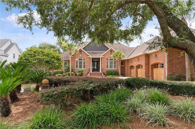 view of front of house with a garage and brick siding