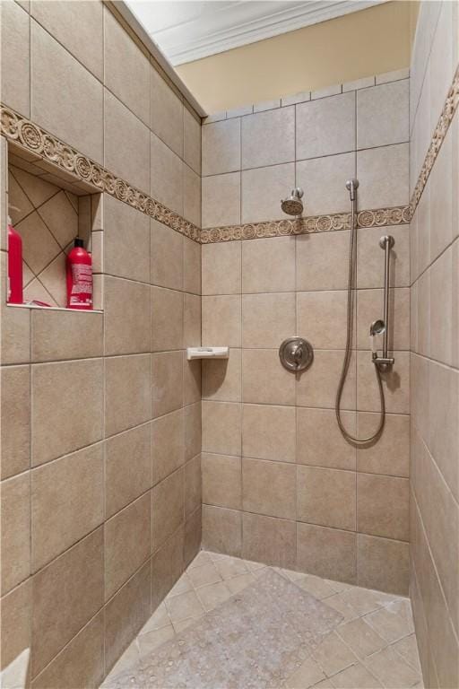 full bathroom with tiled shower and crown molding