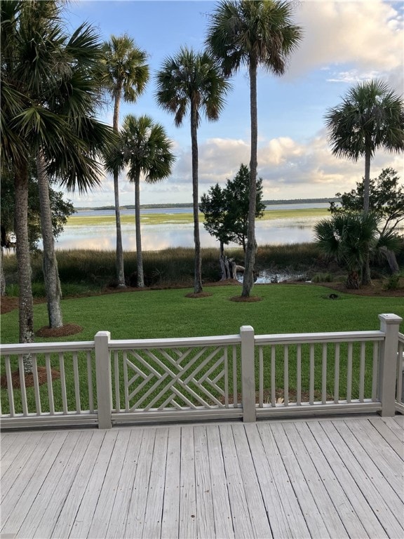 deck featuring a lawn and a water view