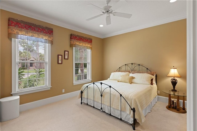 carpeted bedroom with baseboards, ornamental molding, and ceiling fan