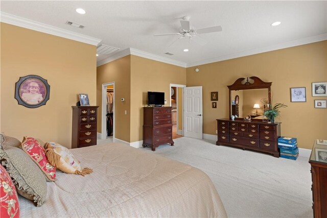 carpeted bedroom with baseboards, visible vents, a walk in closet, crown molding, and recessed lighting