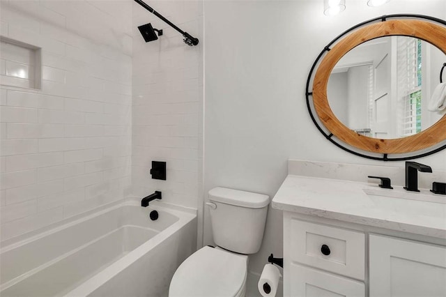 full bathroom with vanity, tiled shower / bath combo, and toilet