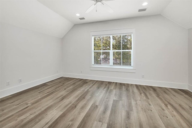 additional living space featuring ceiling fan, light hardwood / wood-style flooring, and vaulted ceiling