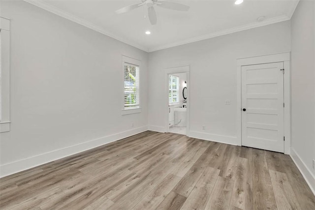 empty room featuring light hardwood / wood-style flooring, ceiling fan, and ornamental molding