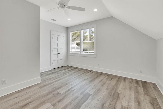 additional living space featuring ceiling fan, lofted ceiling, and light wood-type flooring