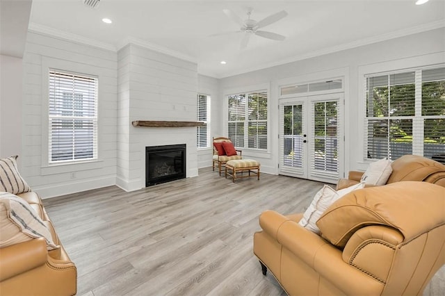 sunroom / solarium featuring ceiling fan, a healthy amount of sunlight, and french doors