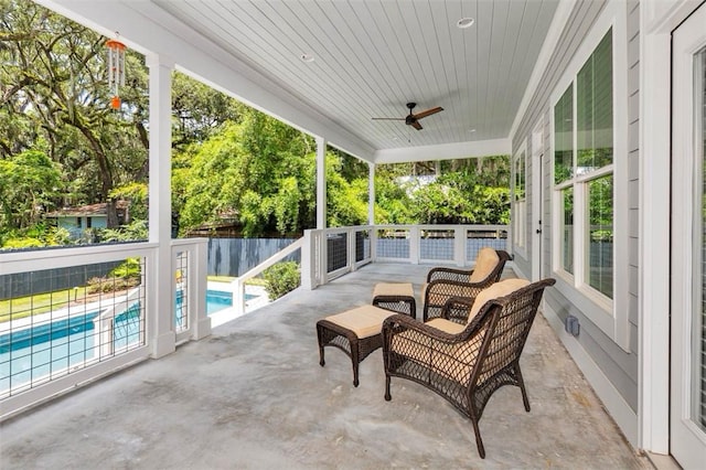 sunroom / solarium with ceiling fan and wood ceiling