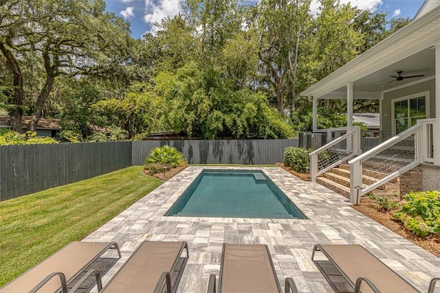 view of swimming pool with a lawn, a patio area, and ceiling fan