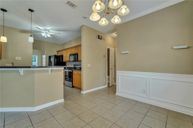 kitchen featuring a breakfast bar area, visible vents, black appliances, brown cabinetry, and pendant lighting