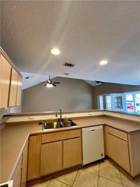 kitchen featuring a textured ceiling, dishwasher, vaulted ceiling, and sink