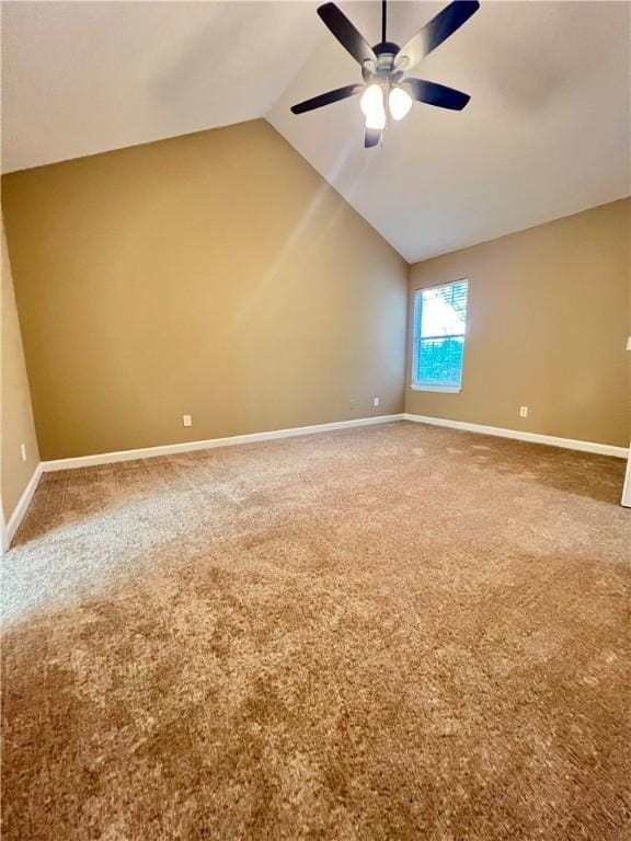 unfurnished room with carpet flooring, ceiling fan, and vaulted ceiling