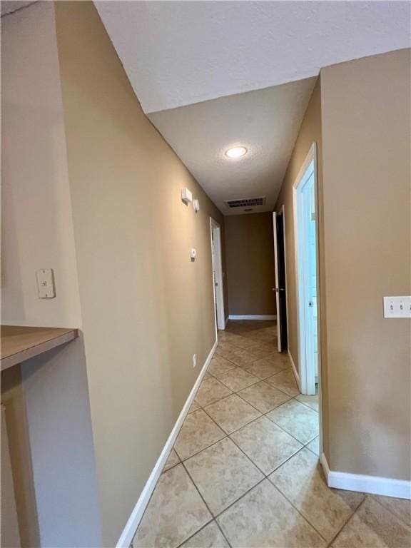 corridor with light tile patterned flooring