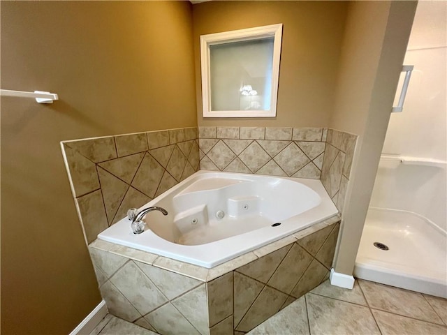 bathroom featuring tiled bath and tile patterned flooring