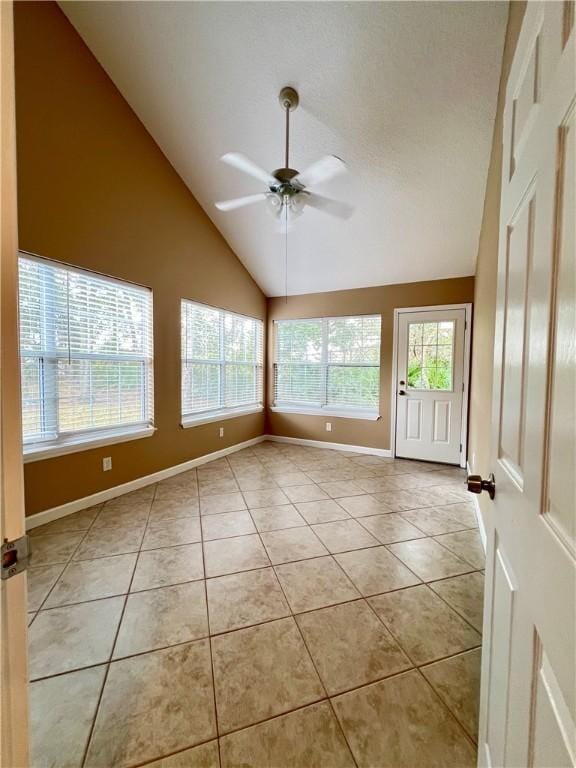 unfurnished room featuring ceiling fan, light tile patterned floors, and high vaulted ceiling