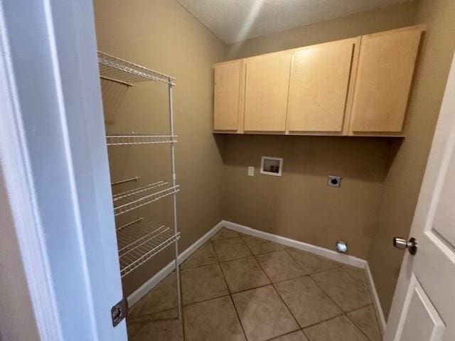 washroom with hookup for a washing machine, light tile patterned flooring, cabinets, and hookup for an electric dryer