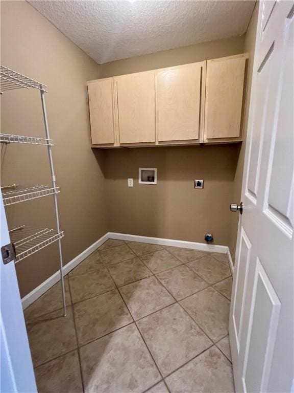 laundry room featuring cabinets, washer hookup, electric dryer hookup, a textured ceiling, and light tile patterned flooring