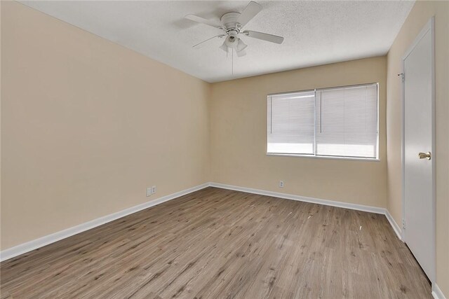 full bathroom featuring a textured ceiling, tile patterned flooring, toilet, vanity, and tiled shower / bath combo