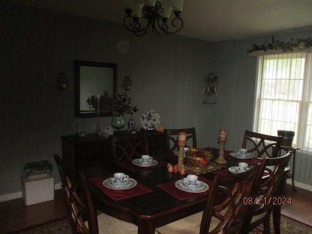 dining room with wood-type flooring and a chandelier