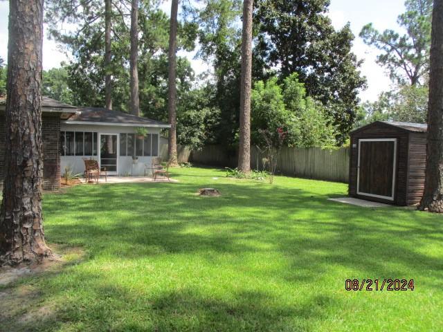 view of yard with a patio and a storage shed