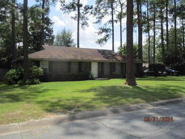 ranch-style home with a front lawn