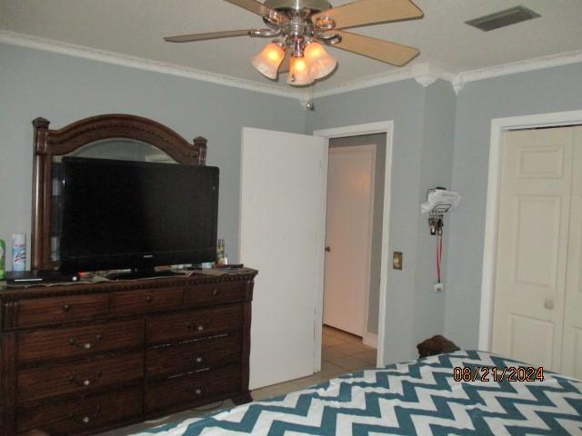 bedroom featuring ceiling fan and ornamental molding