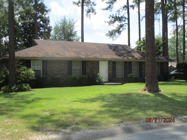 ranch-style home with a front lawn