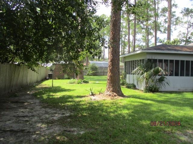 view of yard featuring a sunroom