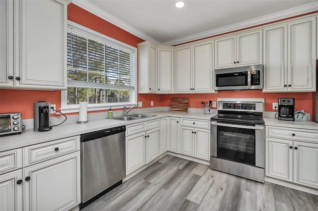 kitchen with a sink, appliances with stainless steel finishes, and light countertops