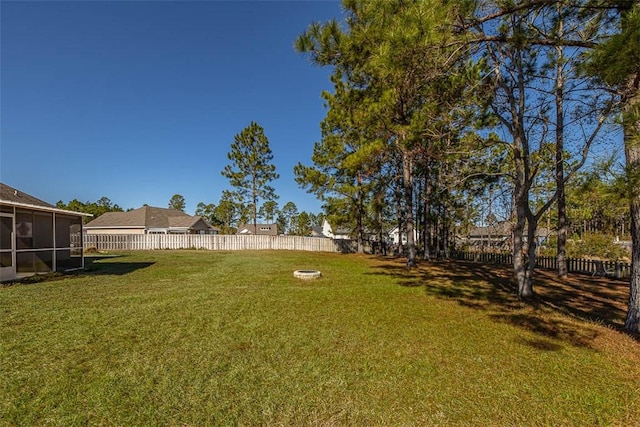 view of yard with a fenced backyard and a sunroom