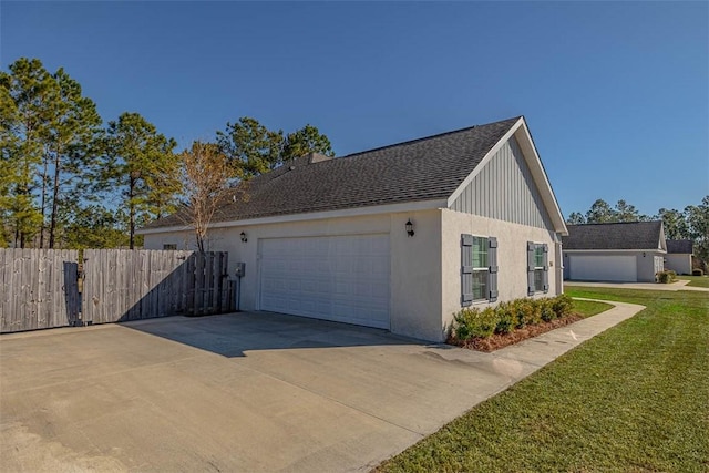 view of side of property featuring stucco siding, driveway, roof with shingles, and fence