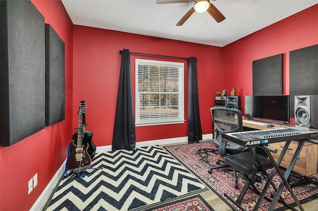 office area featuring baseboards and ceiling fan