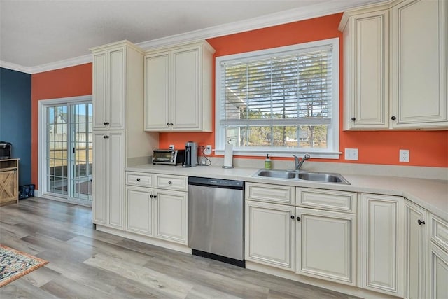 kitchen featuring dishwasher, ornamental molding, a healthy amount of sunlight, and a sink