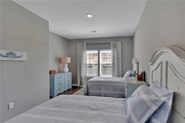 bedroom with dark hardwood / wood-style flooring