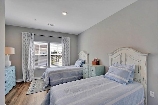 bedroom with hardwood / wood-style floors