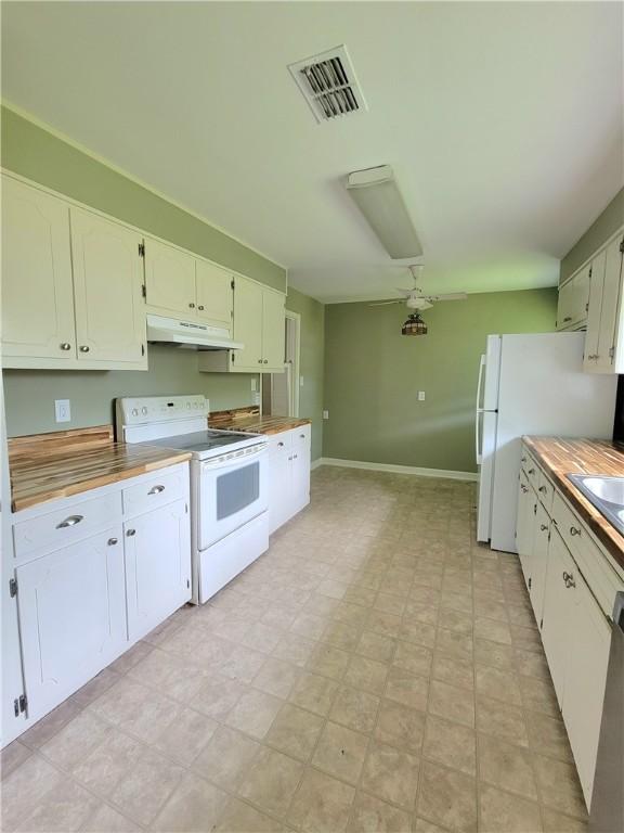903 Atlantic Ave, Waycross, GA 31501 - kitchen featuring white appliances, under cabinet range hood, and white cabinets