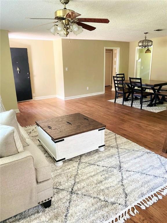 903 Atlantic Ave, Waycross, GA 31501 - living area with ceiling fan, wood finished floors, and a textured ceiling