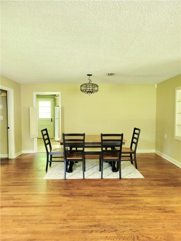 903 Atlantic Ave, Waycross, GA 31501 - dining room with a textured ceiling and light wood-type flooring