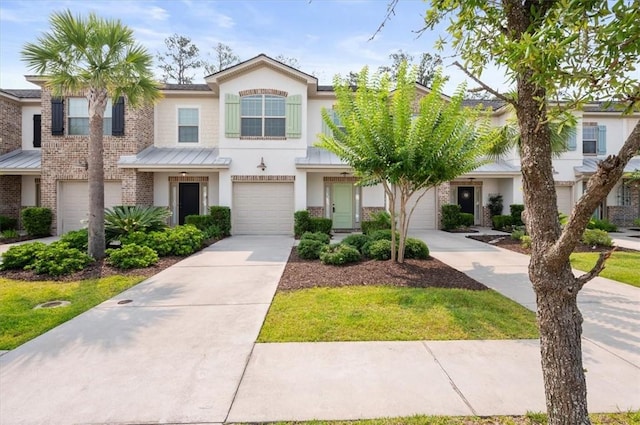 404 Mariners Cir, Saint Simons Island, GA 31522 - view of property with stucco siding, concrete driveway, a standing seam roof, brick siding, and metal roof