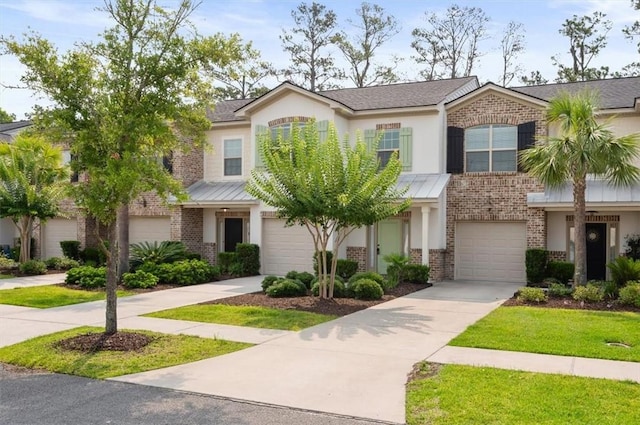 404 Mariners Cir, Saint Simons Island, GA 31522 - view of front of house with brick siding, driveway, an attached garage, and stucco siding