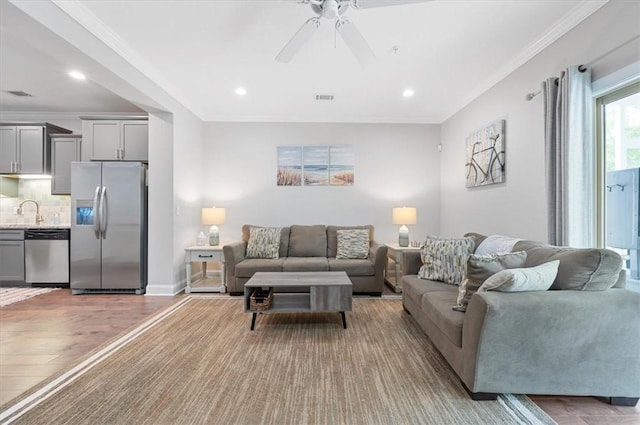 404 Mariners Cir, Saint Simons Island, GA 31522 - living area with ceiling fan, recessed lighting, light wood finished floors, crown molding, and baseboards