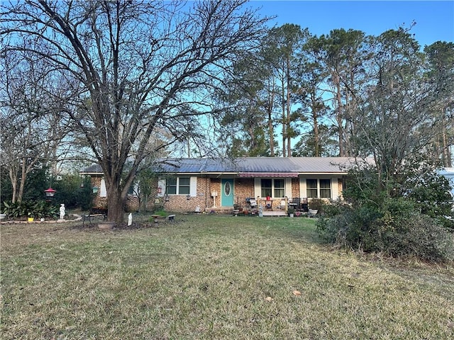 ranch-style home with brick siding and a front yard