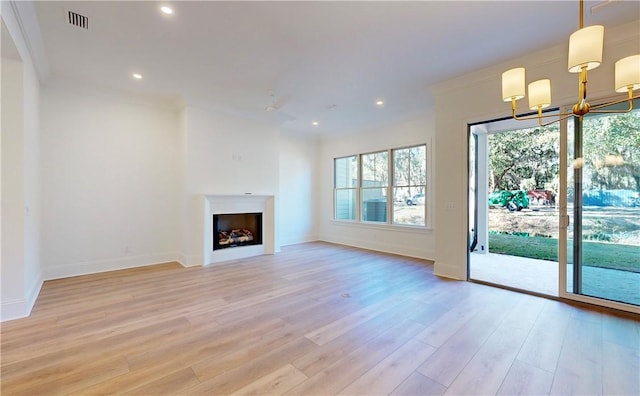 187 Fifty Oaks Ln, Saint Simons Island, GA 31522 - unfurnished living room featuring light wood finished floors, a chandelier, recessed lighting, baseboards, and a fireplace
