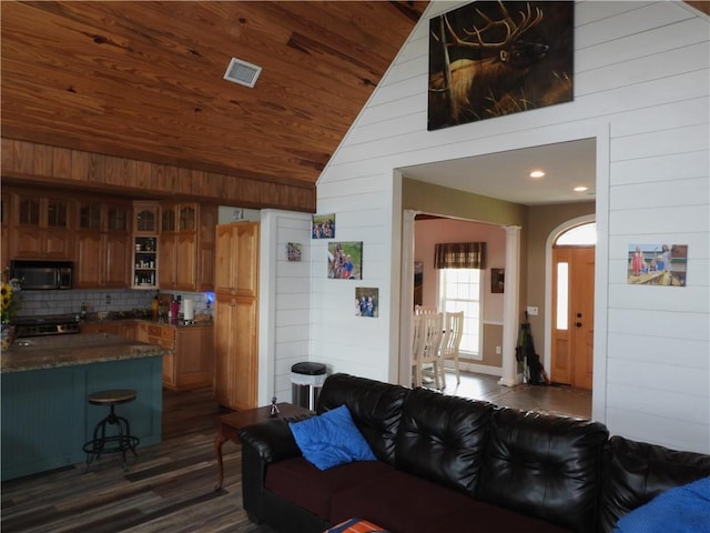 living room with vaulted ceiling, wooden walls, wooden ceiling, and dark hardwood / wood-style floors