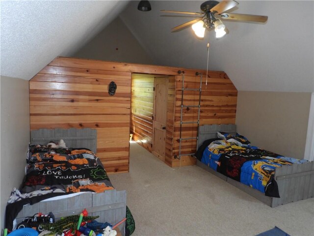 carpeted bedroom featuring wooden walls, ceiling fan, and lofted ceiling