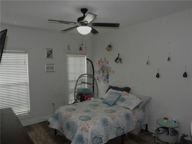 bedroom with ceiling fan and dark wood-type flooring