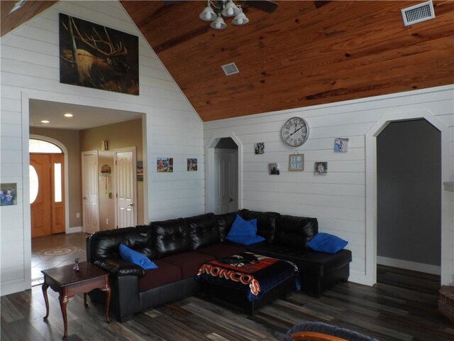 living room featuring wood ceiling, vaulted ceiling, ceiling fan, dark wood-type flooring, and wood walls